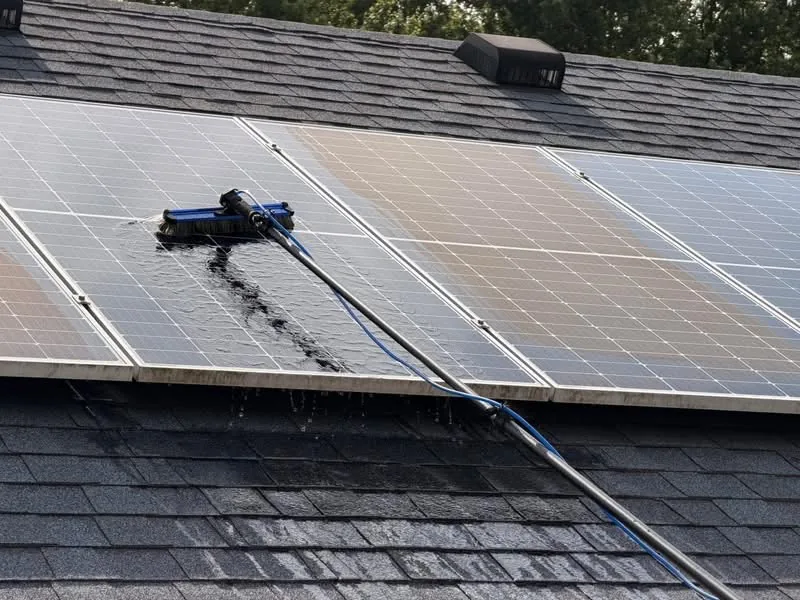 Nonabrasive cleaning equipment being used on residential solar panels